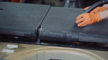 Adam araba iç elektrikli süpürge ile temizler