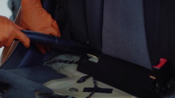 Man cleans car interior with vacuum cleaner — Stock Video