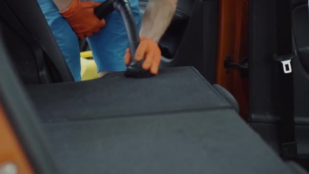 Человек очищает салоны автомобилей пылесосом — стоковое видео