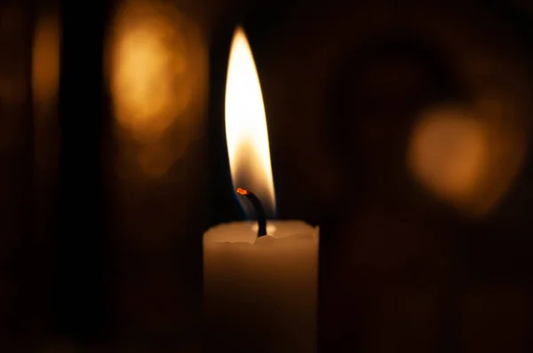 One candle flame at night closeup - isolated, macro