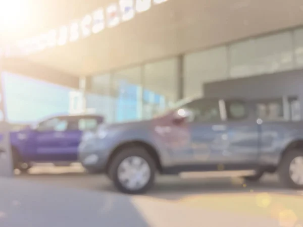 Blur the background of the car and Showroom at blurred in workplace or abstract background of shallow office depth of focus.