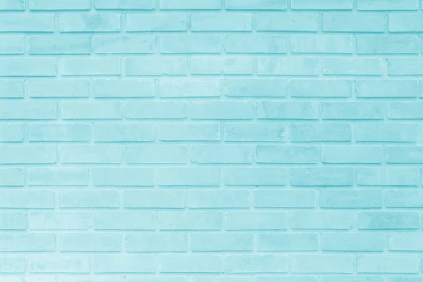 Brick wall painted with pale blue paint pastel calm tone texture background. Brickwork and stonework flooring interior rock old pattern clean concrete grid uneven bricks design stack.