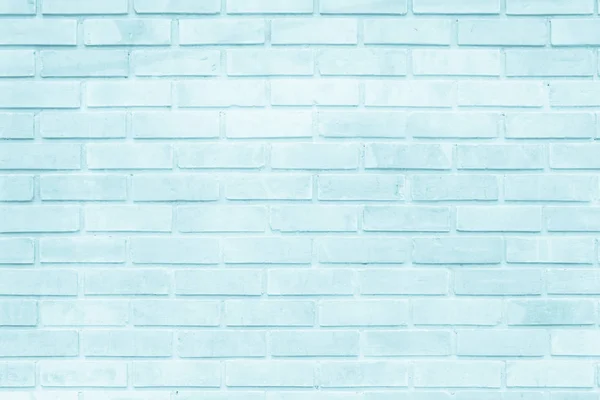 Brick wall painted with pale blue paint pastel calm tone texture background. Brickwork and stonework flooring interior rock old pattern clean concrete grid uneven bricks design stack.