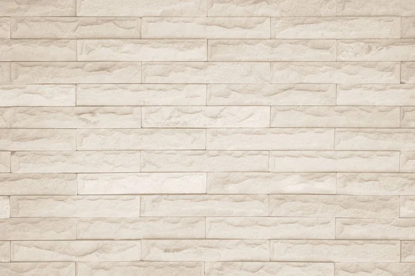 Wall cream brick wall texture background in room at subway. Brickwork stonework interior, rock old clean concrete grid uneven abstract weathered bricks tile design, horizontal architecture wallpaper.