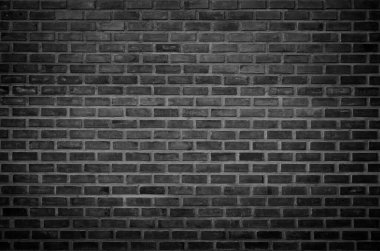 Duvarın koyu duvar dokusu arka planında. Tuğla işçiliği ya da taş döşeme döşeme eski kaya desenleri düz olmayan beton şebeke tuğlaları. Kara tuğla duvar dokusu yüzeyi boş arkaplan dizaynı. Tuğla duvar deseni kasvetli, antika tuğla koyu gri.