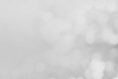 Gri ve beyaz doğa bulanık renkler parlak, parlak, parlak bir yaz. Soyut beyaz desenli, yumuşak ön plan baloncuğu gri renkli parlaklıkta parlıyor. Bulanık duvar.