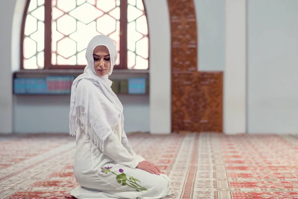 Young beautiful Muslim Woman Praying In Mosque