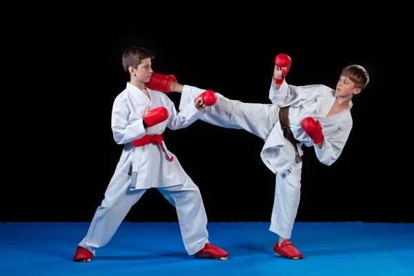 The studio shot of group of kids training karate martial arts — Stock Photo, Image