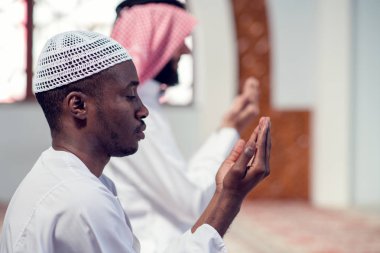 İki dindar Müslüman camide birlikte dua ediyor.