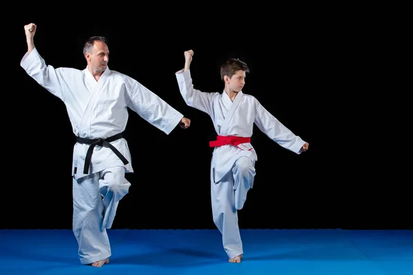 Instructor de karate masculino entrenando a niños pequeños en dojo —  Fotos de Stock