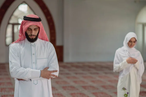 Muçulmano homem e mulher orando por Deus na mesquita juntos — Fotografia de Stock