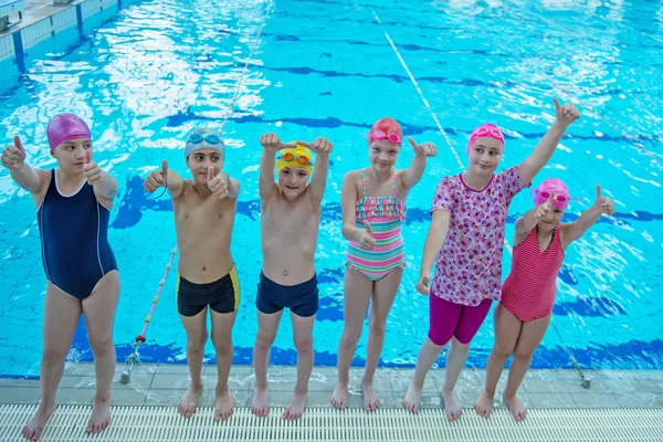 De gelukkige kinderen kids groep op zwembad klasse leren om te zwemmen — Stockfoto