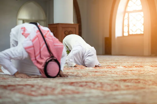 Homem e mulher muçulmanos rezando na mesquita — Fotografia de Stock