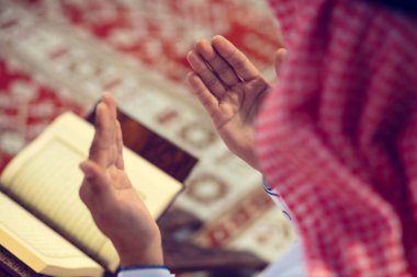 Dindar Müslüman adam caminin içinde dua ediyor.