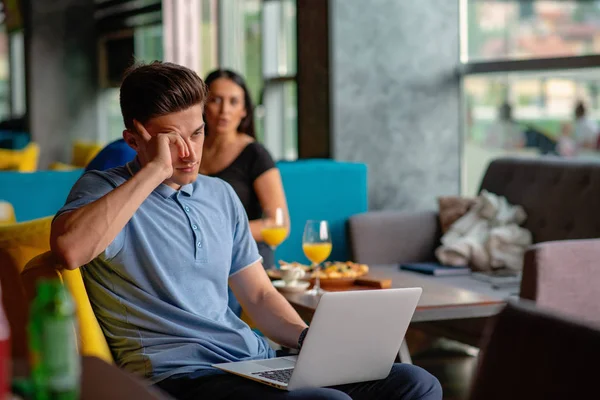 Giovane freelance maschio qualificato che inizia la giornata lavorativa presto al mattino bevendo caffè per svegliarsi — Foto Stock