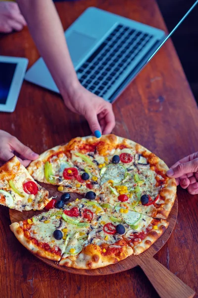 Mock up freelancer workplace. Tablet PC, cell phone and pizza. Top view image. Fast pizza delivery