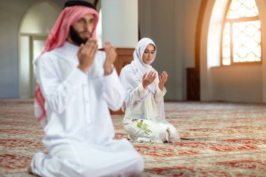 Muslim Praying man and woman in mosque clipart