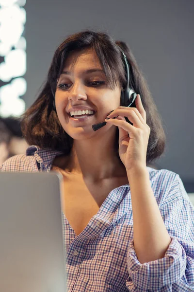 Beautiful phone operator Arab woman working in modern startup office