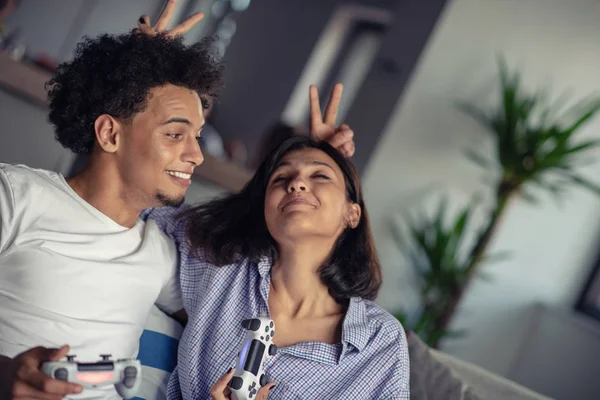 Pareja joven disfrutando jugando videojuegos juntos . — Foto de Stock