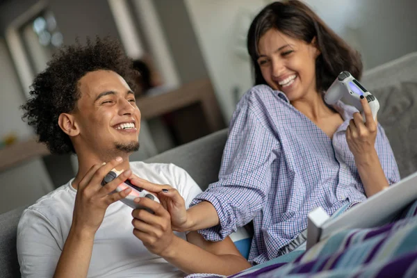 Young couple enjoying playing video games together.