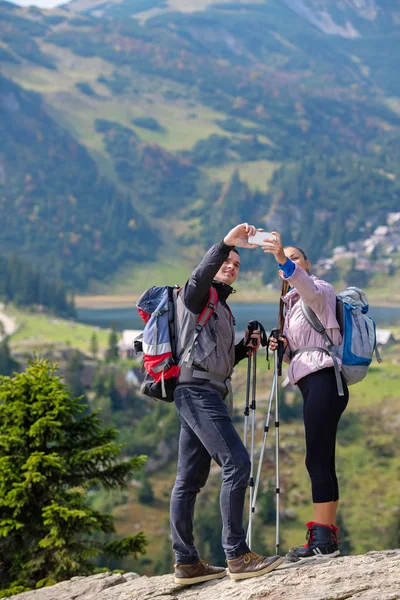 Two hikers taking selfie on top of the mountain — Stock Photo, Image