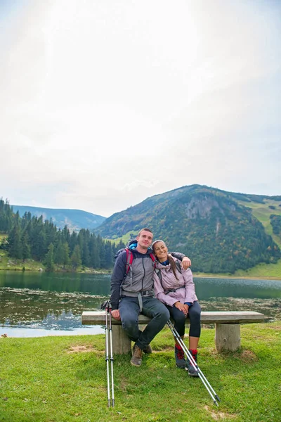 Young couple of backpackers near the lake in mountains — Stock Photo, Image