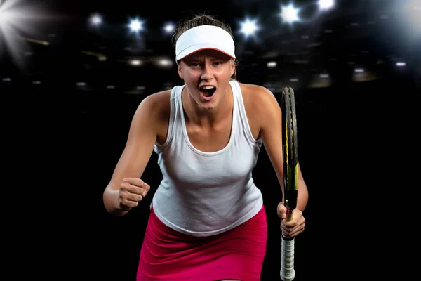 Hermosa chica tenista con una raqueta sobre fondo oscuro wiht luces celebrando una victoria impecable — Foto de Stock