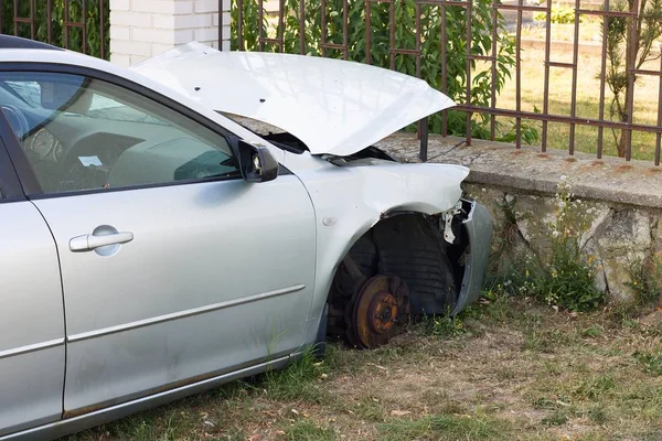 Car crashed head on into the wall (of local cemetery). Picture taken several days after accident