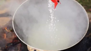 Demir kazanda dışarıda yemek pişirmek.