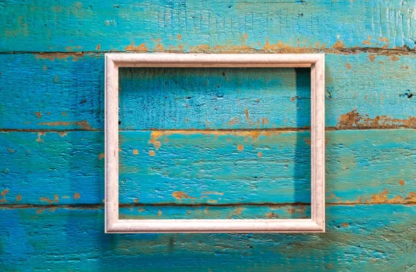 Fotoğraf ve resim mavi dokulu ahşap arka plan üzerinde beyaz renk için boş bir çerçeve