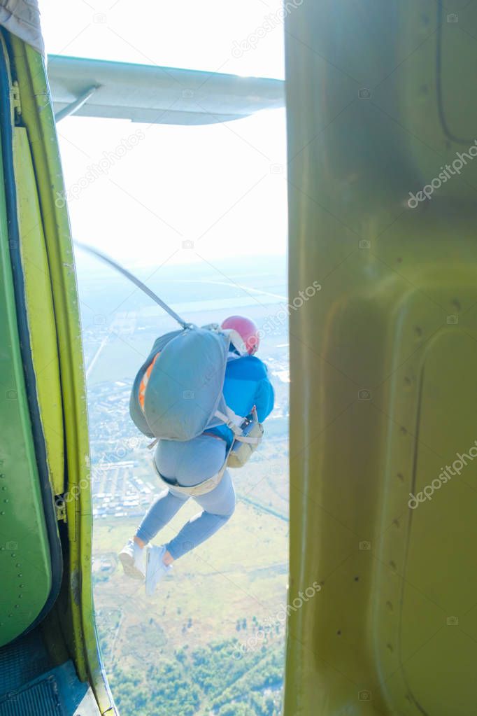 paratroopers amateurs jump out of the door of the plane summer sunny day