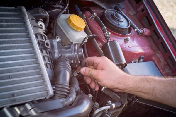 repair and maintenance of the car, men's hands hold technical car engine service