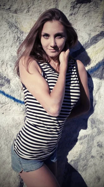 Portrait of a slender young woman in T-shirt, vest — Stock Photo, Image