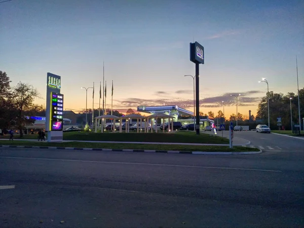 Gasolinera, hora azul, las luces de la ciudad — Foto de Stock