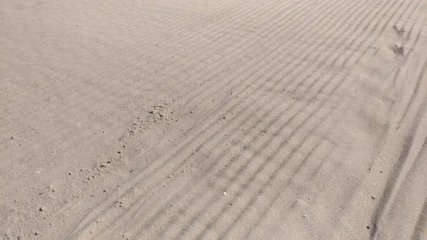 Sand on the beach after being smoothed — стоковое фото