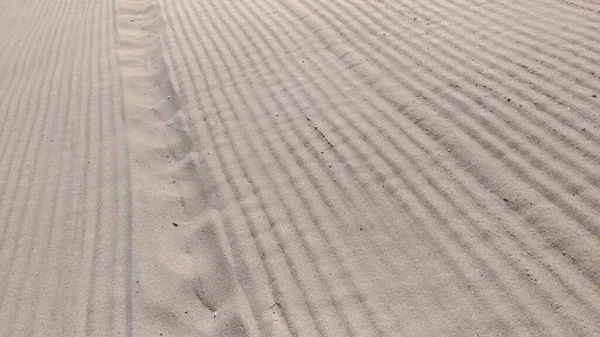 Sand on the beach after being smoothed — стоковое фото