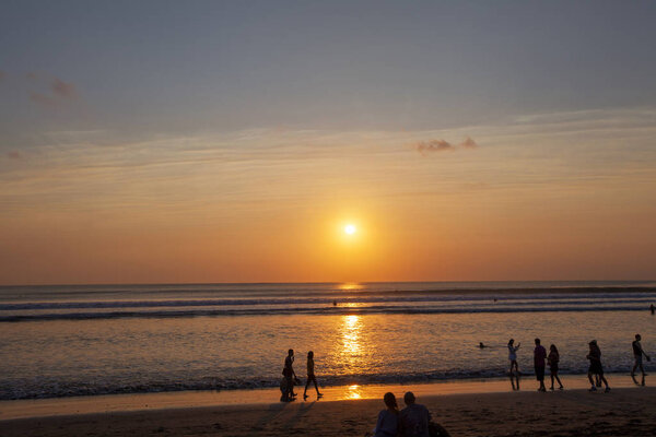 People enjoy sunset at Seminyak (Kuta) Bali - Indonesia