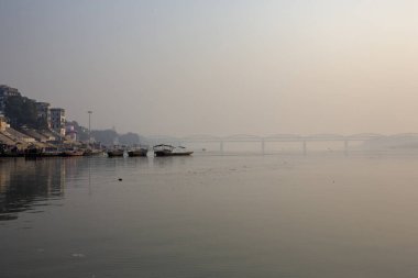 Wooden boats at sacred river Ganges in Varanasi, India. Malviya Bridge in the background, India