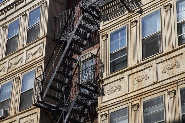 Fire escape stairs-downtown back alley architecture-steel and yellow brick background