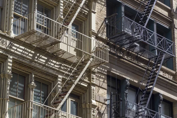 Fire escape stairs-downtown back alley architecture-steel and red brick background