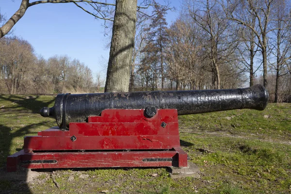 the old ship cannon with wooden carriage and black metal barrel