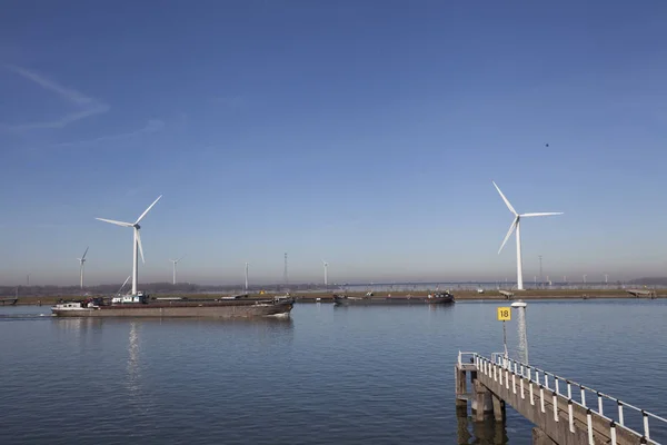 Wind mill, with several wind turbines, near a river, producing g — Stock Photo, Image