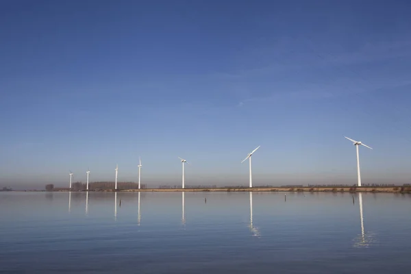 Modern windmills in the water near the shore in the netherlands — Stock Photo, Image