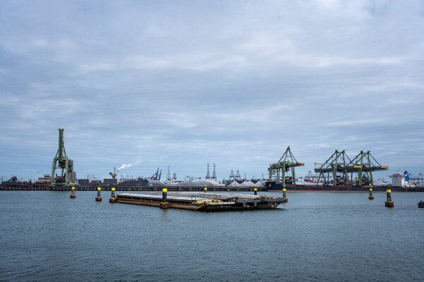 big container ships with cranes in the harbor of rotterdam netherlands