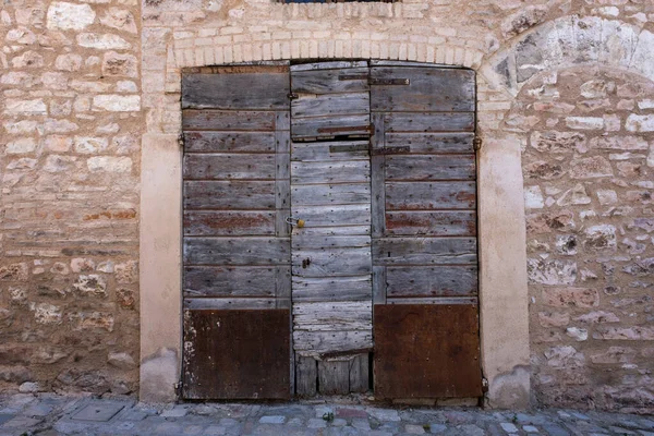 Classic painted wooden door with bronze handles in Lucca italy
