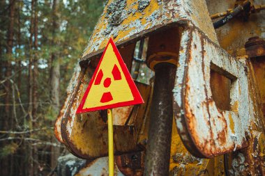 Radiation Sign - triangular warning yellow sign of radiation hazard in the zone of radioactive fallout in Pripyat city. Chernobyl exclusion zone
