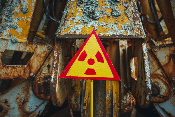 Radiation Sign - triangular warning yellow sign of radiation hazard in the zone of radioactive fallout in Pripyat city. Chernobyl exclusion zone