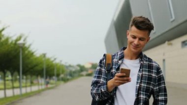 Adam bir bardak kadar Havaalanı terminal yürüyüş ve akıllı telefon kullanma sırt çantası ile kapatmak.