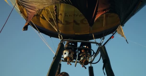 Närbild av ballong elden brinnande i mitten och att göra det flyga. Ballongen flyger i himlen. — Stockvideo