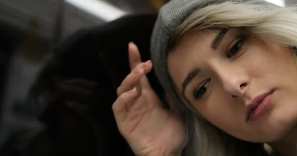 Close up shot of depressed, sad girl riding a public transport at night. She looking out the window and breathing heavily — Stock Video